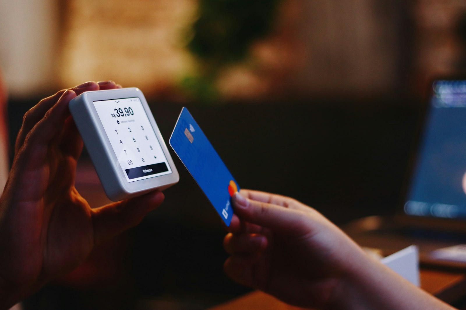 A customer tapping a card to pay at checkout